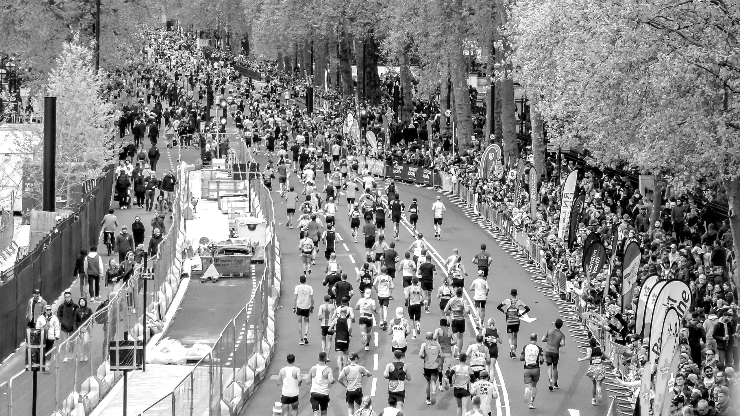 Marathon runners on a city embankment