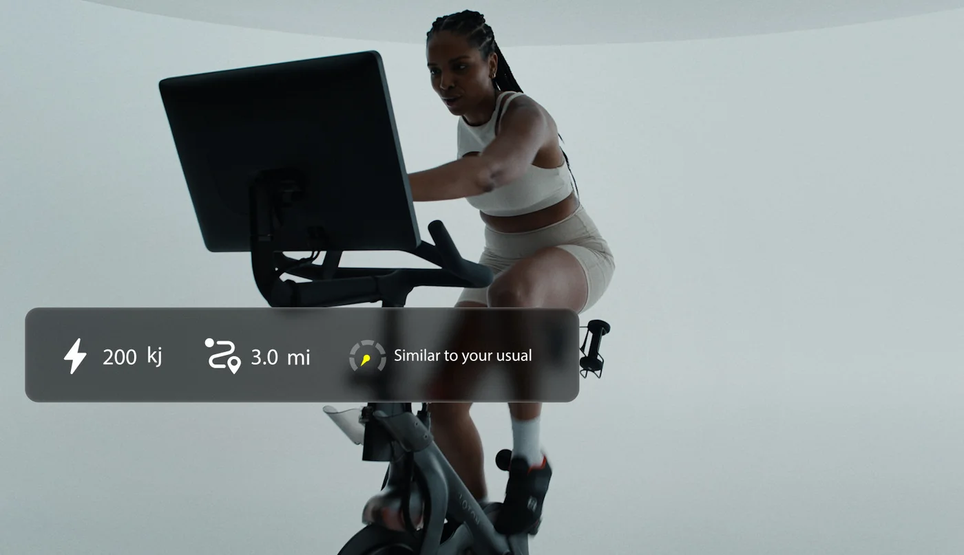 Rider on a Peloton Bike+ with an on-screen summary of 200 kJ output and 3.0 miles, marked similar to their usual effort