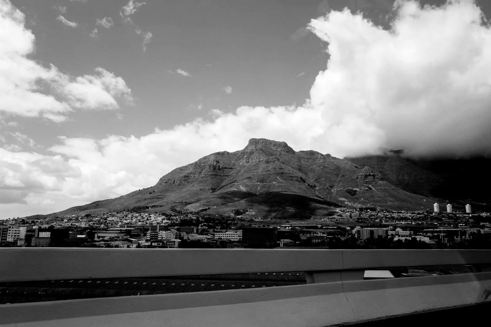 Table Mountain above the Cape Town city bowl, with a bank of cloud behind it.