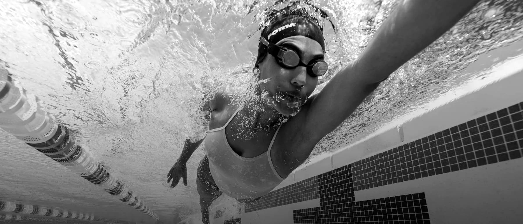 Swimmer in a pool wearing FORM smart swim goggles
