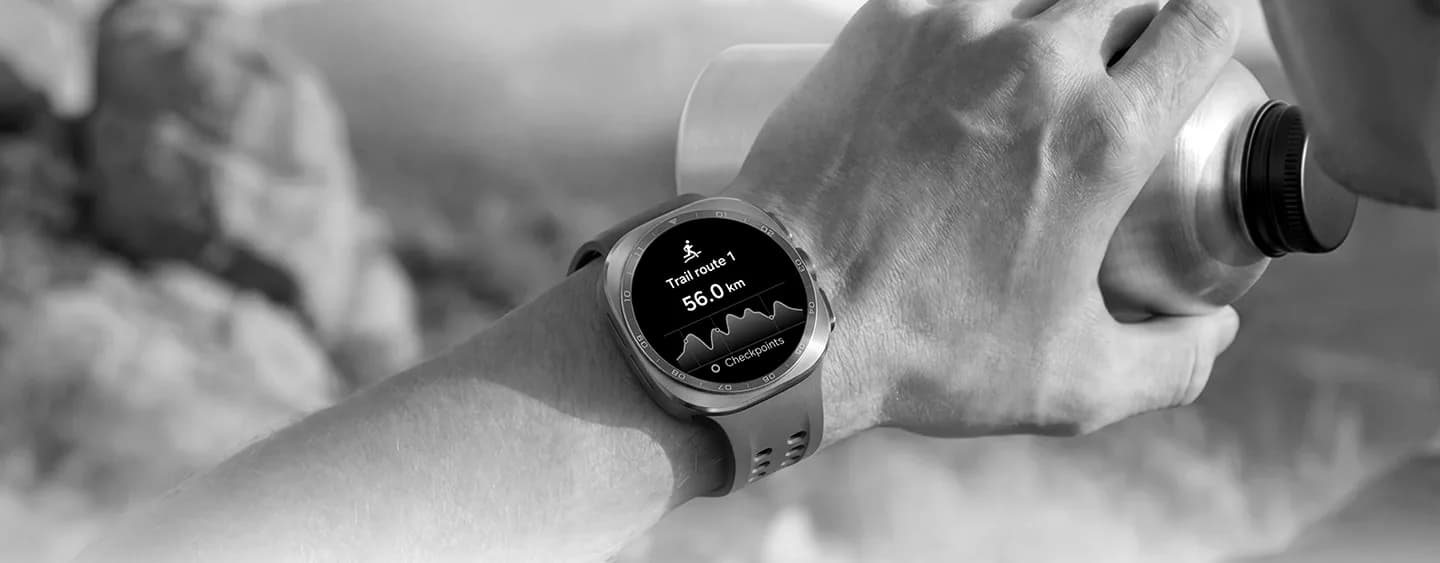 Galaxy Watch on an athlete's wrist showing a workout while they drink from a bottle outdoors