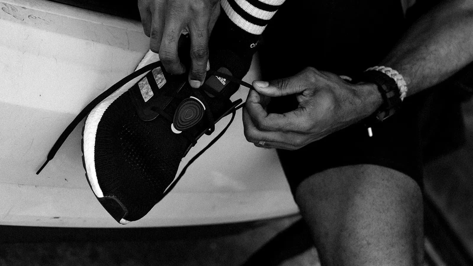 Stryd footpod being clipped onto a running shoe